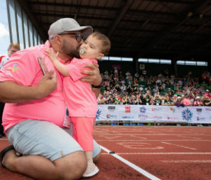 Mia hugging her dad after crossing the finishing line at the Briitsh Transplant Games.