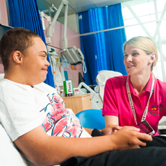 Play specialist talking to male patient