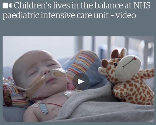 Baby in hospital bed with soft toy