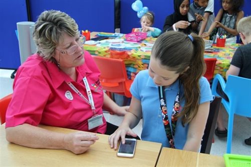 Young girl learning to use the new app