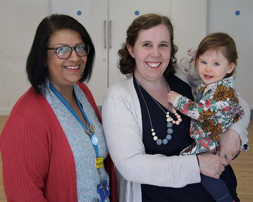 Midwife Bev posing with mum Niamh holding baby Sophie
