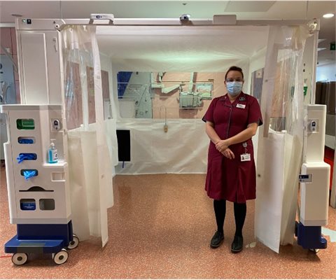 Shona Perkins standing in front of a rediroom at Evelina London