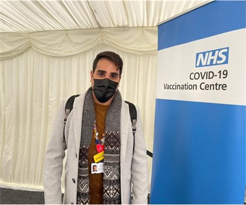 Dr Ranj vaccine with a sign that says NHS COVID-19 Vaccination Centre