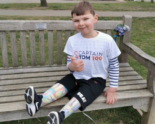 Tony sitting on a park bench with a Captain Tom 100 t-shirt on.