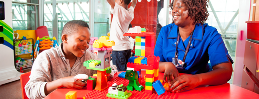Boy and nurse playing with lego