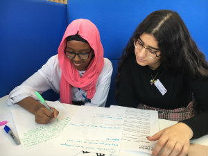 Students learning how to write a press release on Takeover Day