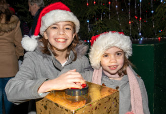 Emilia with sister Lily and the big red button that turns on the London Eye