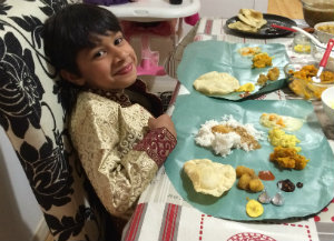 Akira at a table with lots of different kinds of food.