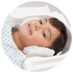 Boy with headphones going into MRI