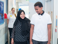 Patient waving goodbye to hospital staff member