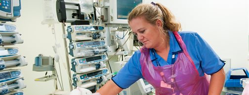A nurse cares for a baby in the children's intensive care unit (PICU).
