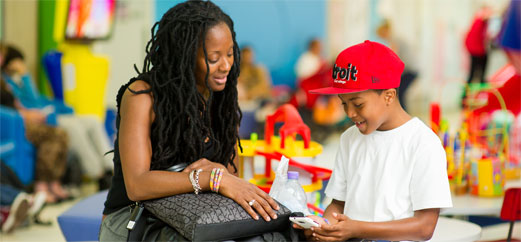 Mum and son in waiting area at Evelina London